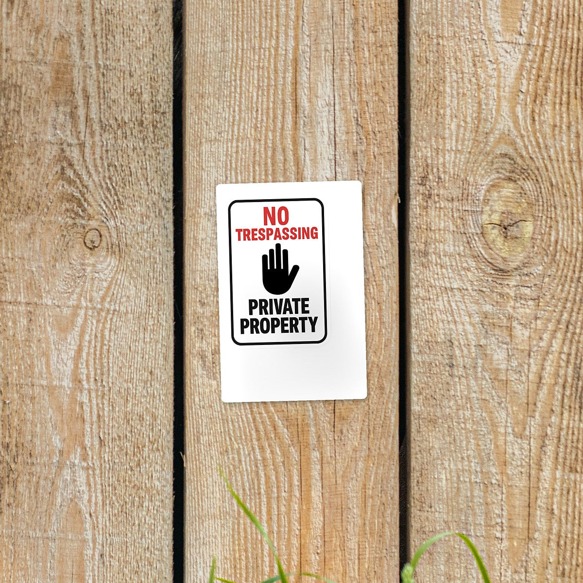 No Trespassing Private Property sticker on a wooden fence