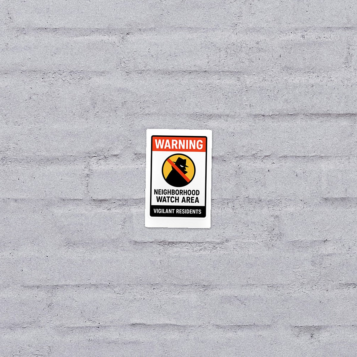 Neighborhood Watch sticker on a brick wall
