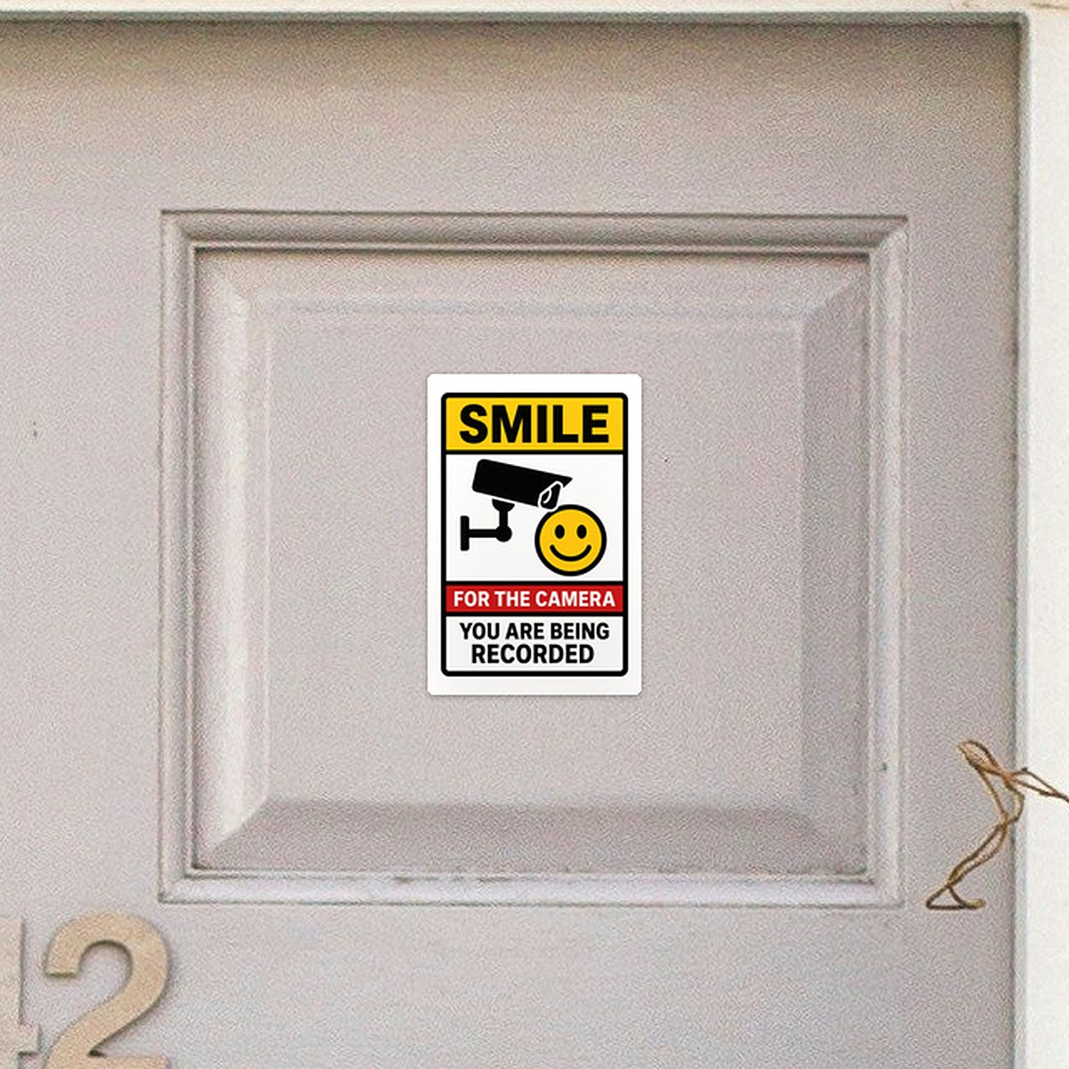 Smile You Are Being Recorded sticker on a front door