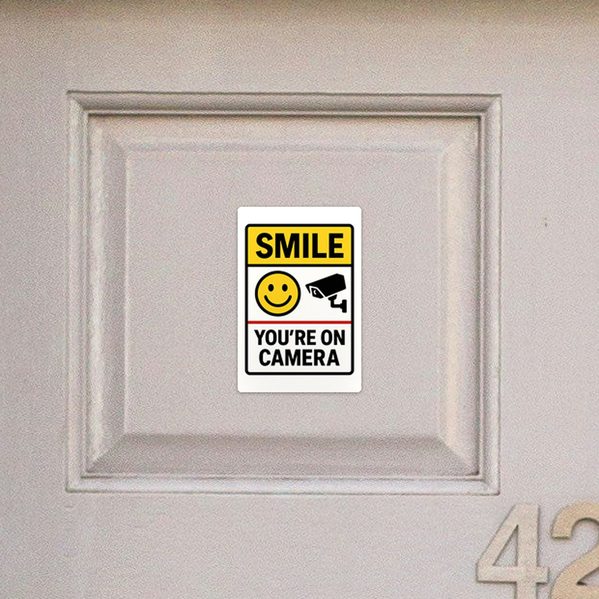 Smile You're On Camera sticker on a front door