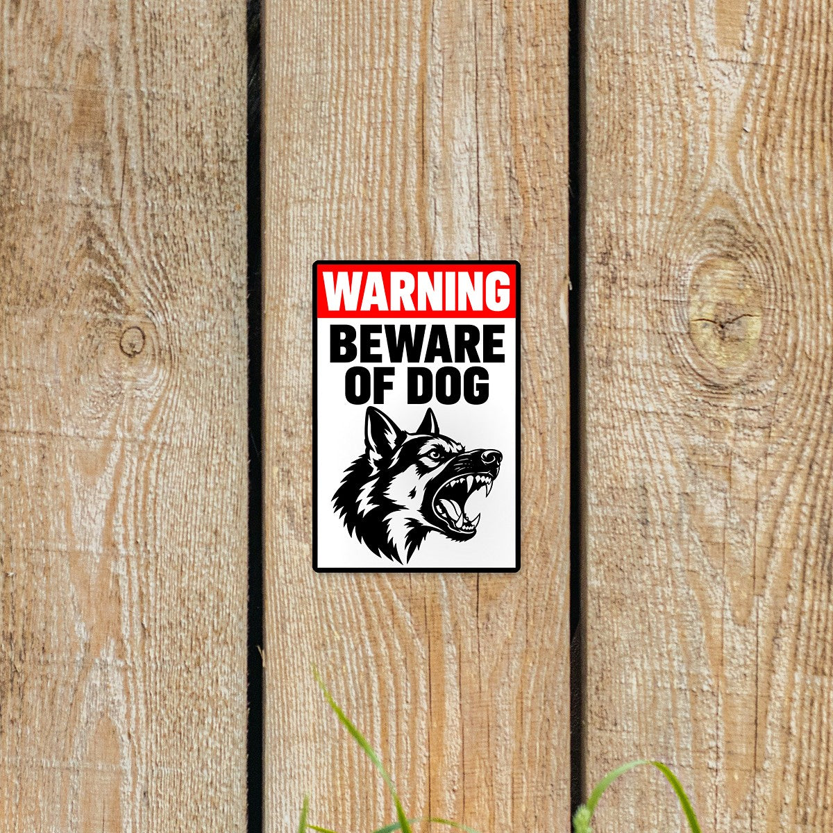 Beware of Dog sticker on a wooden fence