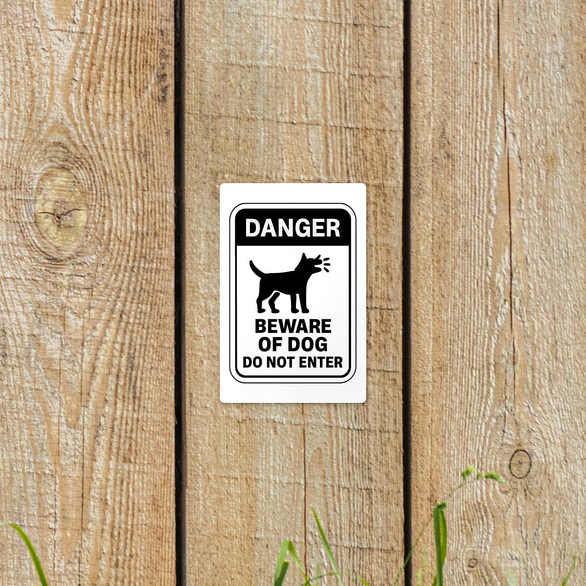 Beware of Dog Do Not Enter sticker on a wooden fence